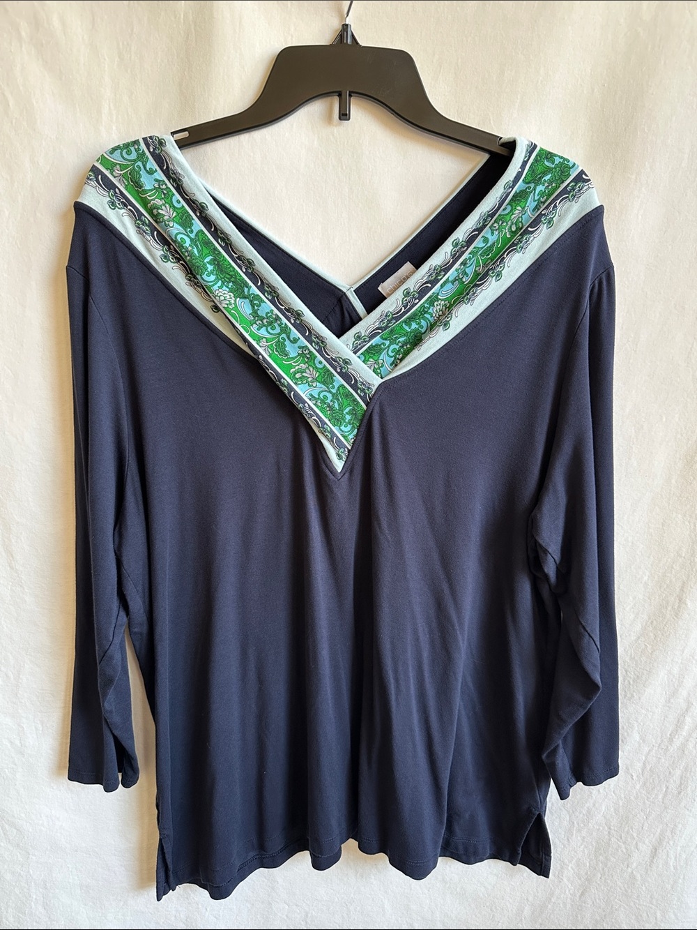 Chico's navy V-neck top with green-blue-white floral neckline trim, size 3 (XL)